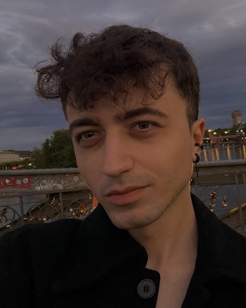 Portrait of Marcos Lázaro at dusk, on a bridge over a river